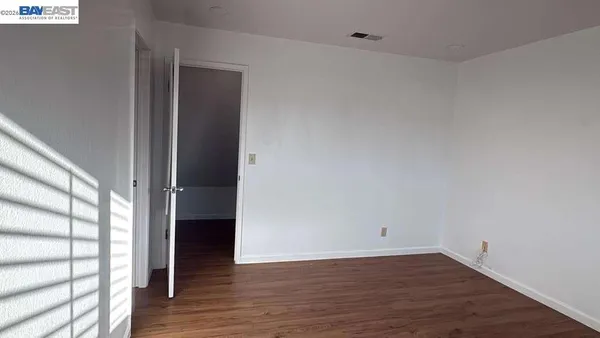 a view of a room with wooden floor