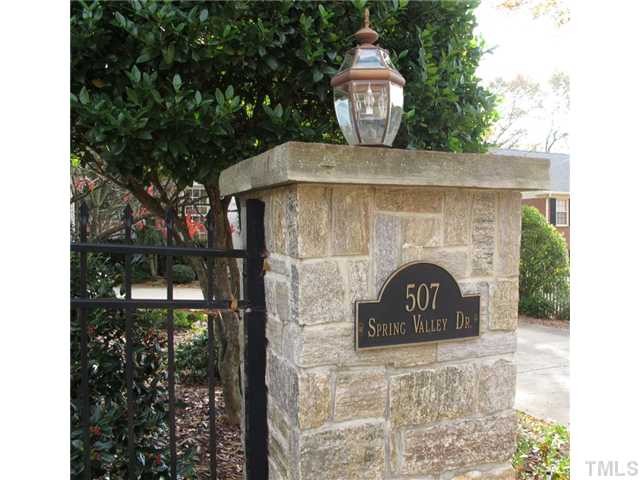 507 Spring Valley Drive Raleigh, NC 27609 - Photo 4 of 25 Stone columns and black aluminum fencing surround this lovely lot.