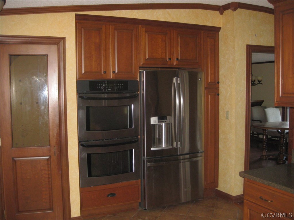 8810 Wells Road Wilsons, VA 23894 - Photo 10 of 31 a kitchen with a refrigerator and cabinets