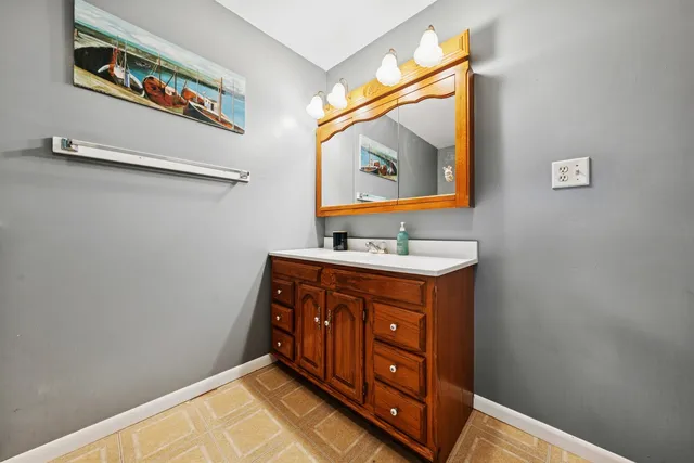 a bathroom with a sink mirror and vanity