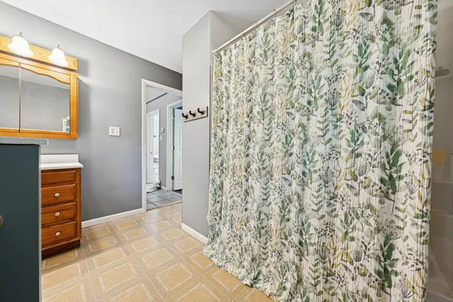 a bathroom with a shower curtain and a sink