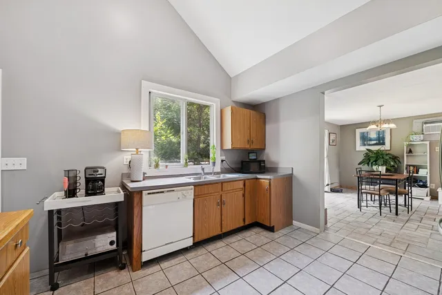 a kitchen with appliances a sink and cabinets