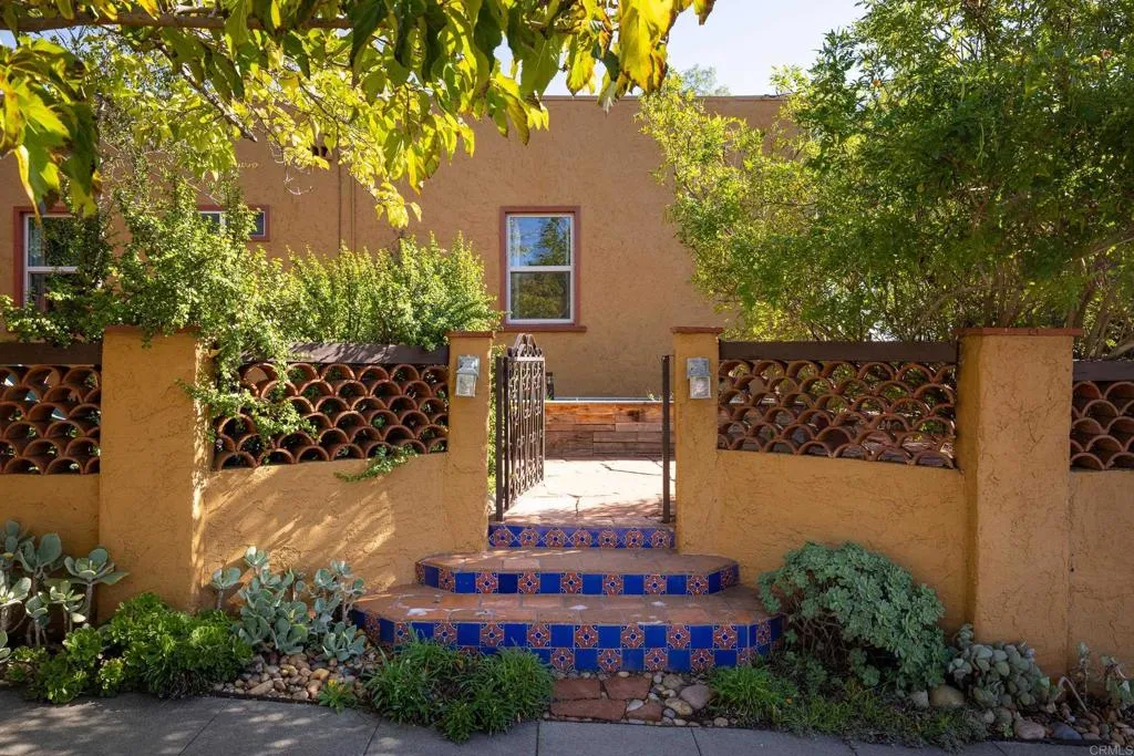 1603 Felton Street San Diego, CA 92102 - Photo 4 of 55 a tall yellow building with trees in front of it