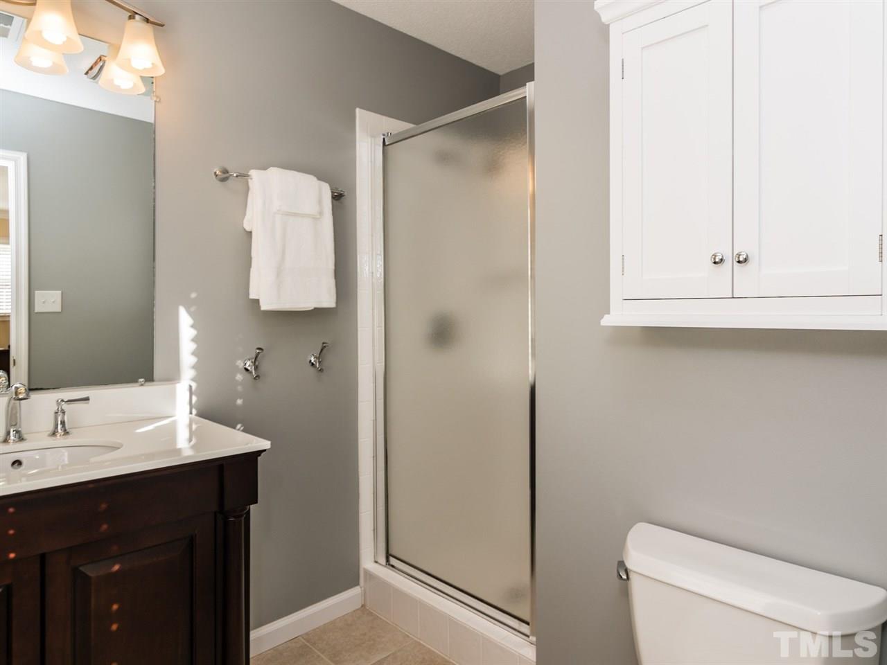 112 Trackers Road Cary, NC 27513 - Photo 16 of 25 The updated master bath has tile flooring and a lovely tile shower.