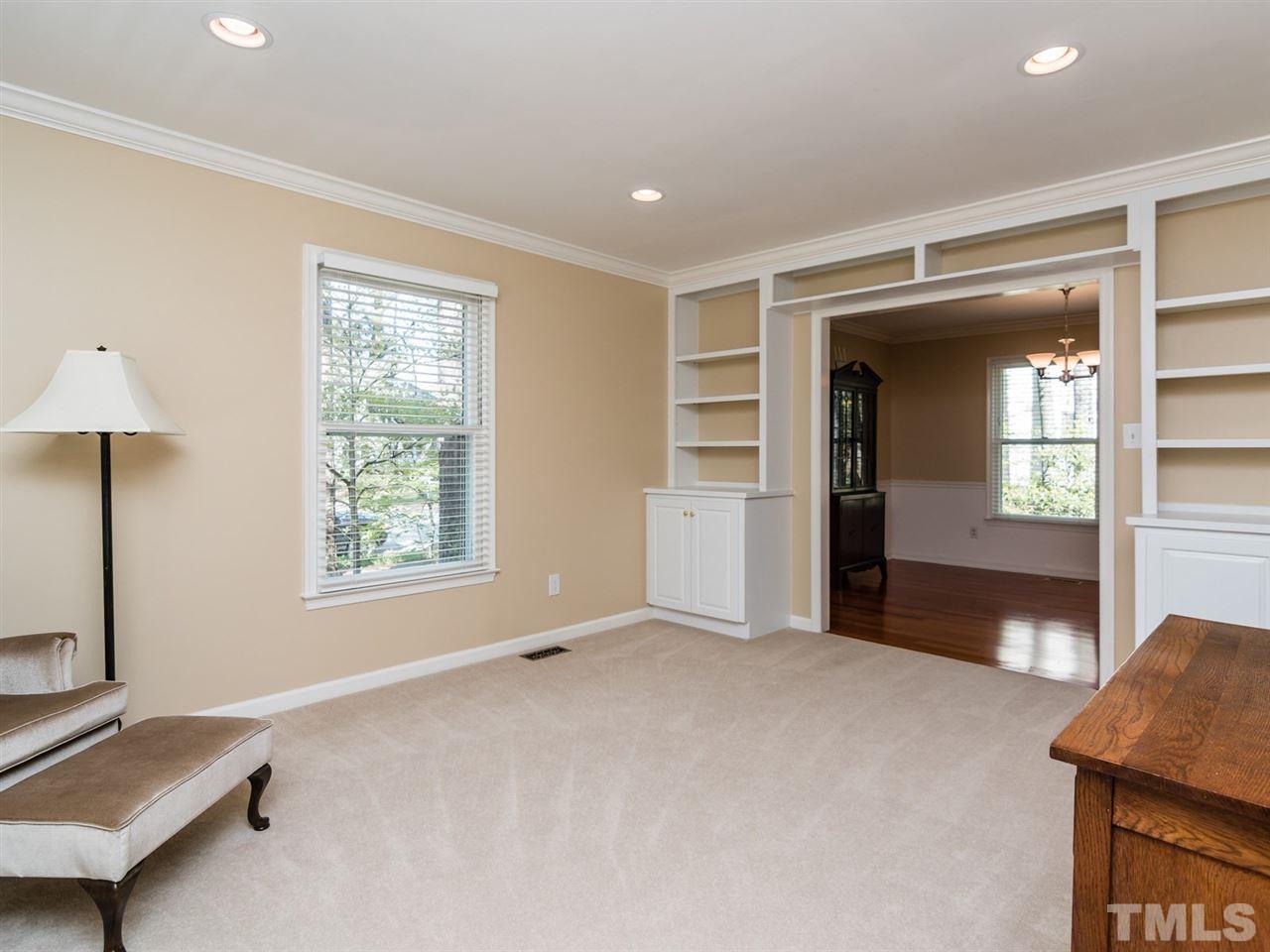 112 Trackers Road Cary, NC 27513 - Photo 3 of 25 The charming living room has built-ins, crown molding and carpeting. This home has lots of space for entertaining.