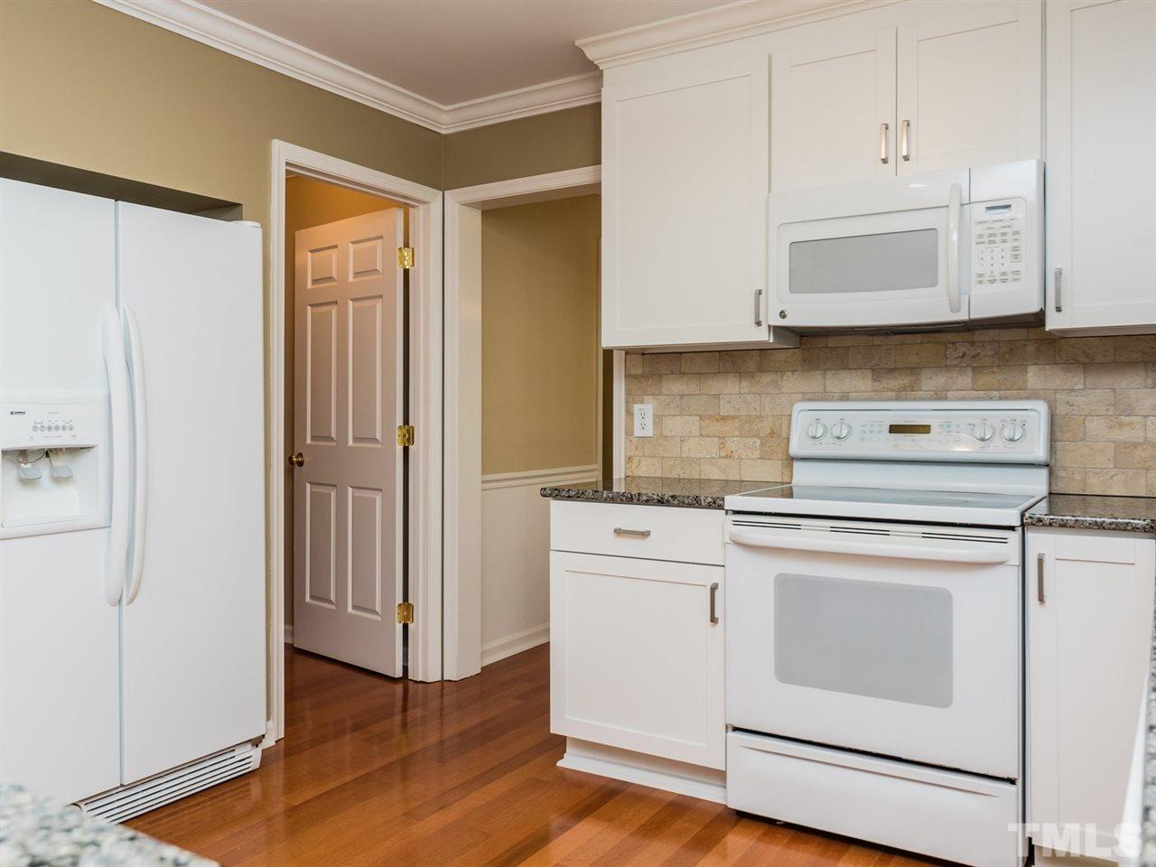 112 Trackers Road Cary, NC 27513 - Photo 6 of 25 The updated kitchen boasts granite counters and beautiful white cabinetry.