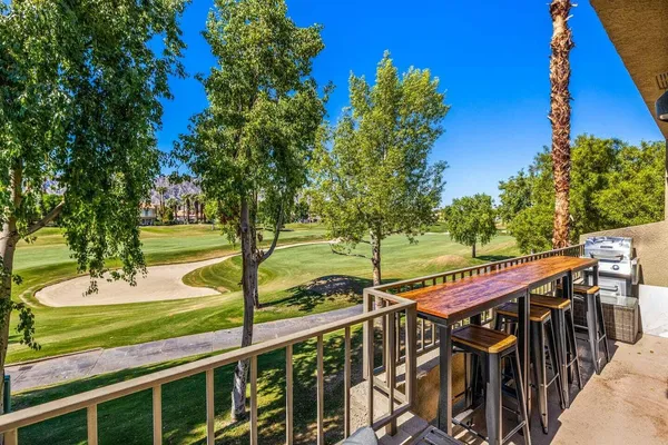 a view of a balcony with yard