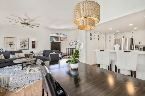 a living room with furniture a chandelier and a dining room