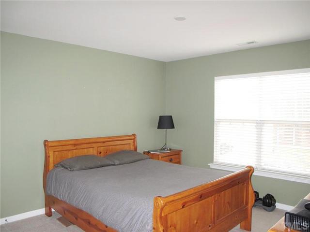 5443 Shaker Heights Lane Raleigh, NC 27613 - Photo 11 of 14 a bedroom with a bed and a window