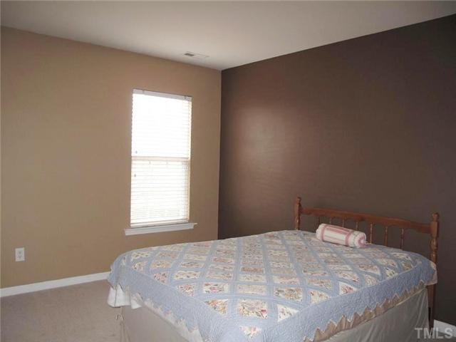 5443 Shaker Heights Lane Raleigh, NC 27613 - Photo 12 of 14 a bedroom with a bed and a window