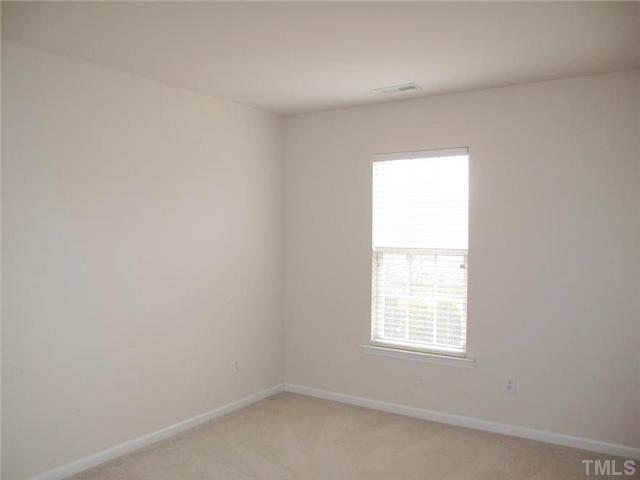 5443 Shaker Heights Lane Raleigh, NC 27613 - Photo 13 of 14 an empty room with a window