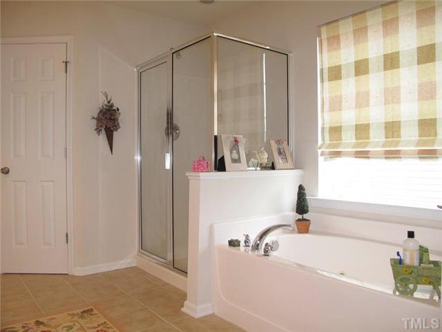 5443 Shaker Heights Lane Raleigh, NC 27613 - Photo 9 of 14 a bathroom with a bathtub and a sink