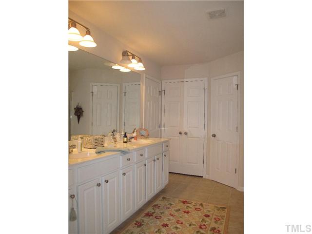 5443 Shaker Heights Lane Raleigh, NC 27613 - Photo 10 of 14 a view of a bathroom with sink and mirror