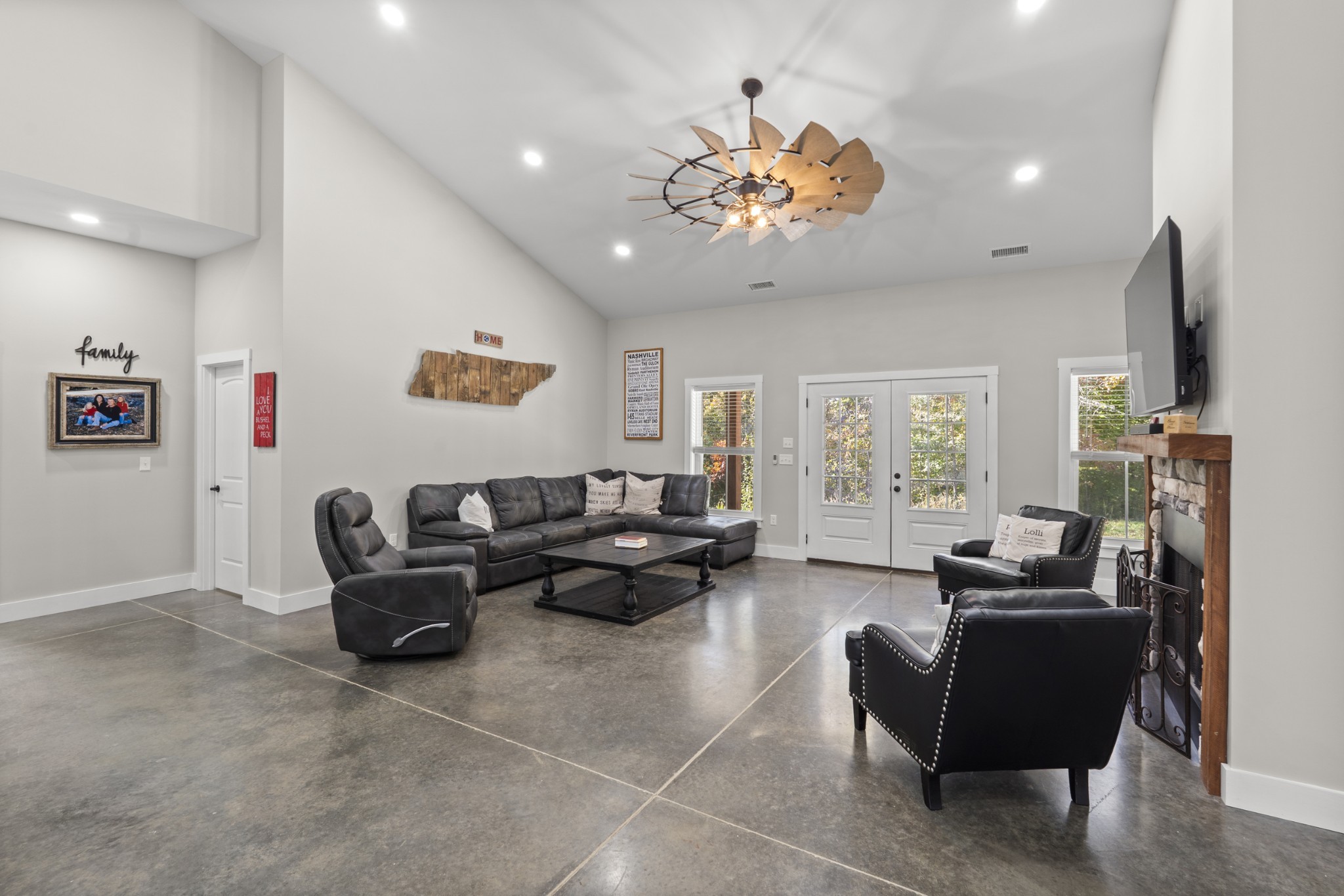 594 Highway 100 Centerville, TN 37033 - Photo 11 of 40 a living room with furniture a flat screen tv and a chandelier