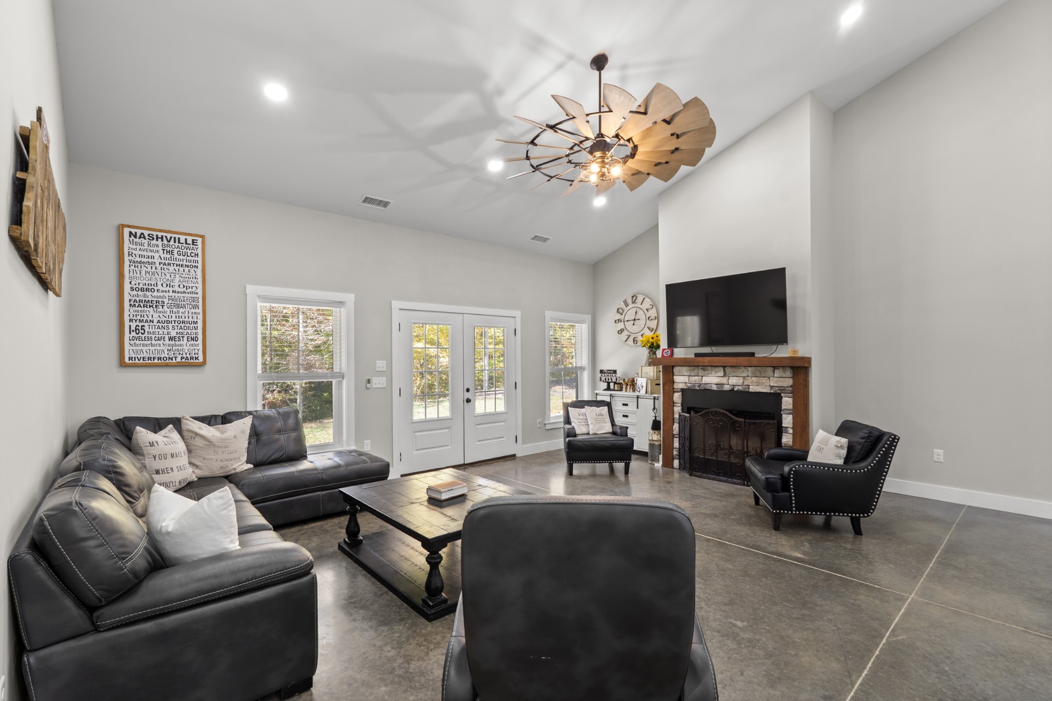 594 Highway 100 Centerville, TN 37033 - Photo 12 of 40 a living room with furniture a chandelier and a flat screen tv