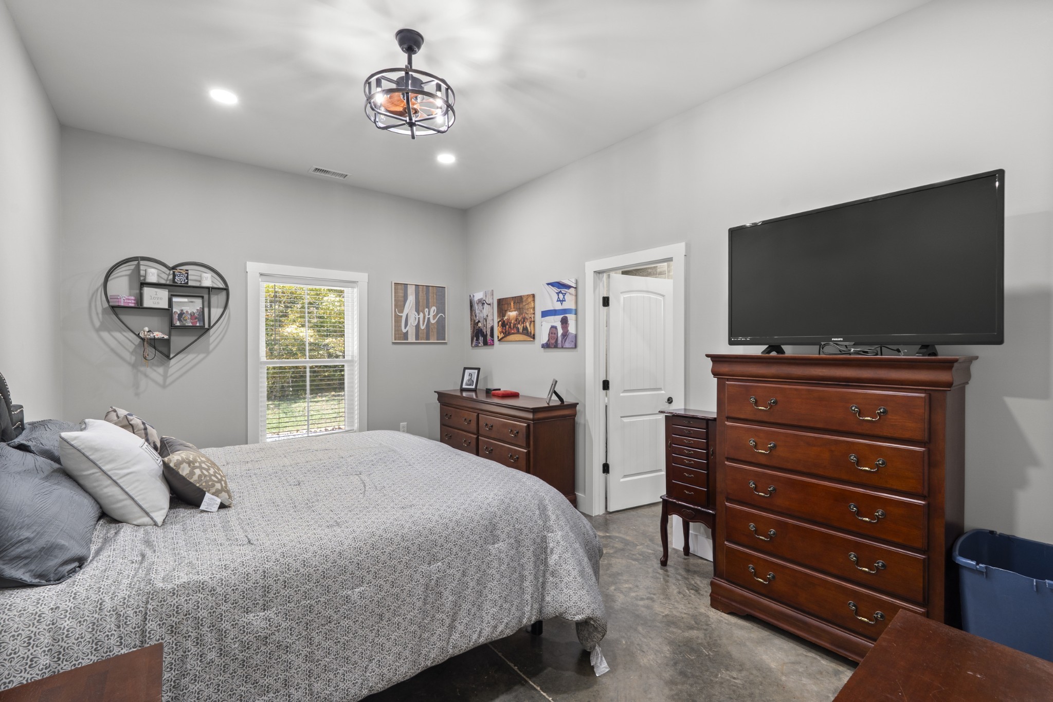 594 Highway 100 Centerville, TN 37033 - Photo 14 of 40 a bedroom with a bed and a flat screen tv