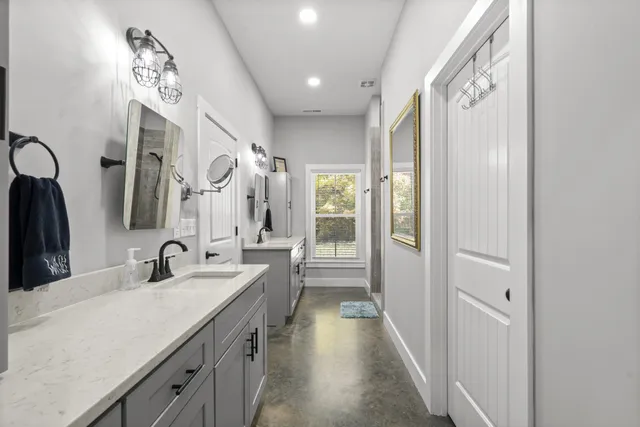 a bathroom with a double vanity sink and a mirror