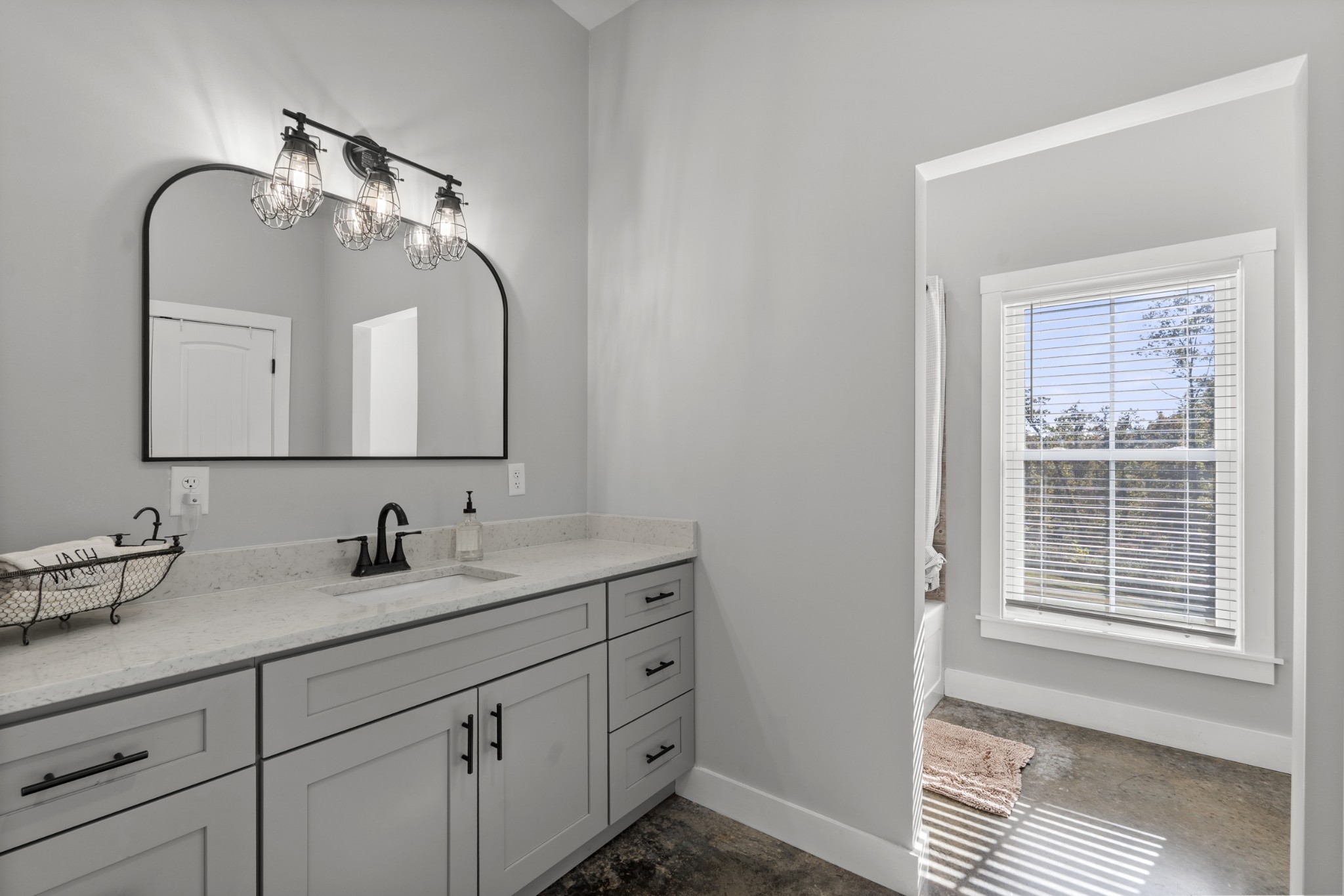 594 Highway 100 Centerville, TN 37033 - Photo 20 of 40 a bathroom with a double vanity sink and mirror with window