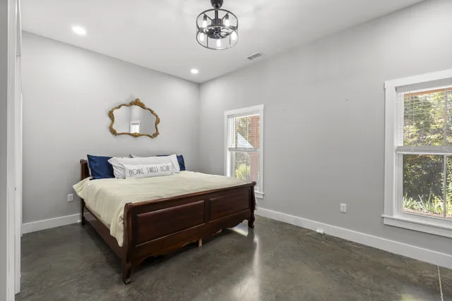 a bedroom with a bed and a window