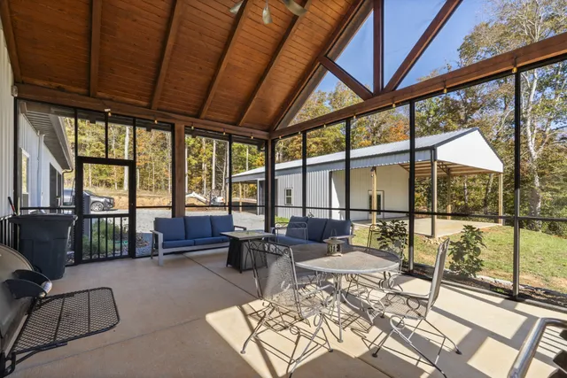 a living room with furniture and a floor to ceiling window