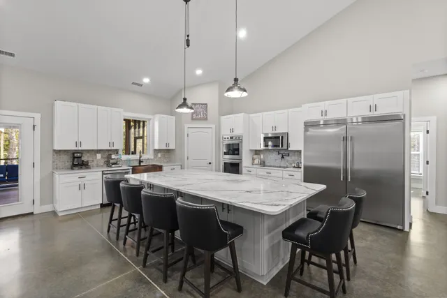 a large kitchen with a table and chairs