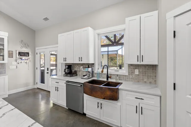 a kitchen with cabinets a sink and appliances