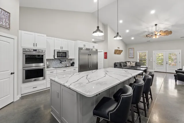 a large kitchen with a table and chairs