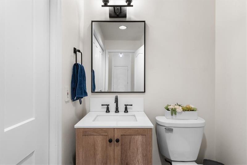 3475 Oak Valley Road Northeast, Unit 410 Atlanta, GA 30326 - Photo 10 of 36 a bathroom with a sink toilet and a mirror