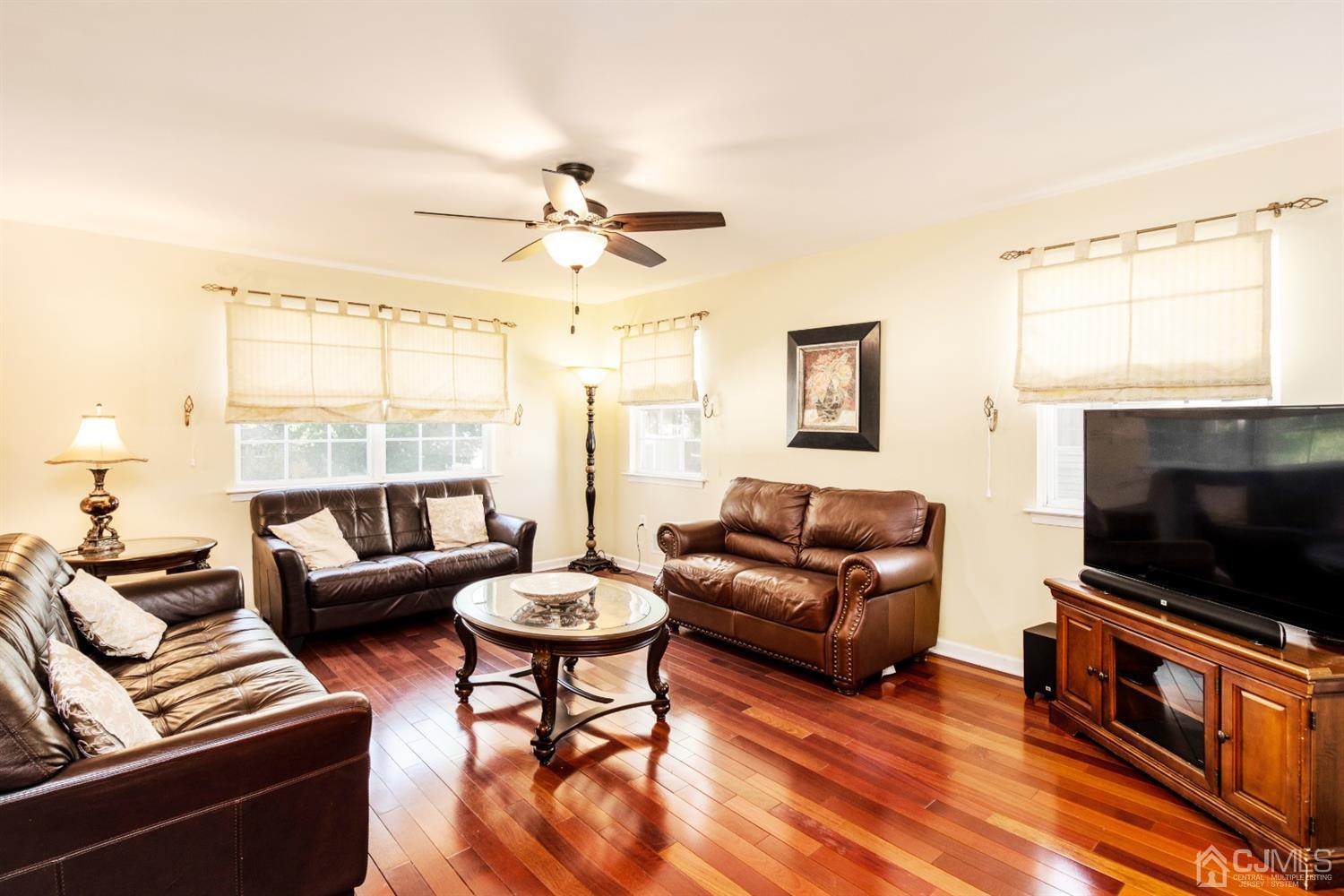 14 Pointer Place Kendall Park, NJ 08824 - Photo 12 of 34 a living room with furniture a flat screen tv and a large window