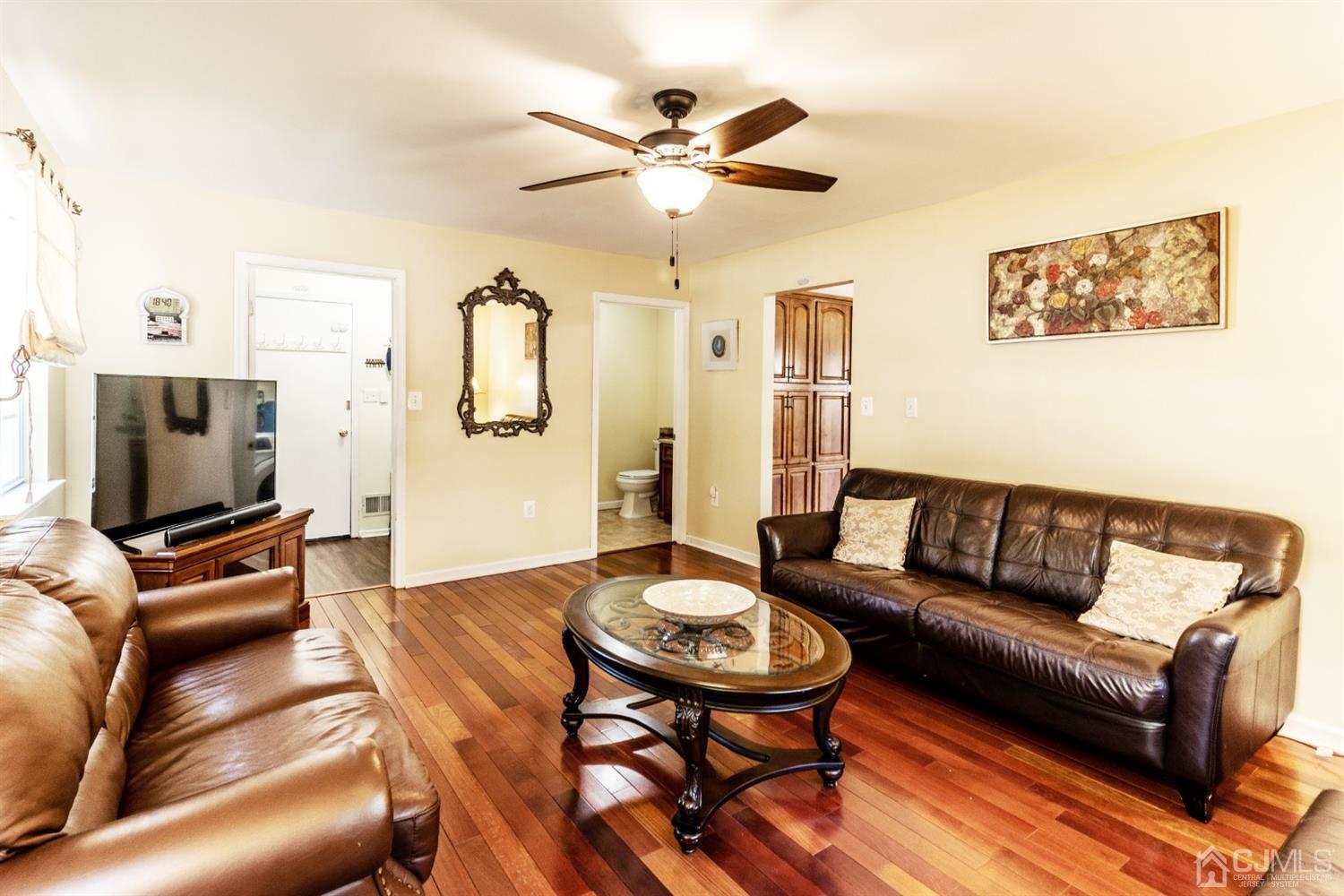 14 Pointer Place Kendall Park, NJ 08824 - Photo 13 of 34 a living room with furniture and a flat screen tv