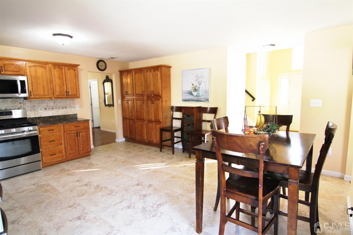 14 Pointer Place Kendall Park, NJ 08824 - Photo 18 of 34 a view of a dining room with furniture and a kitchen