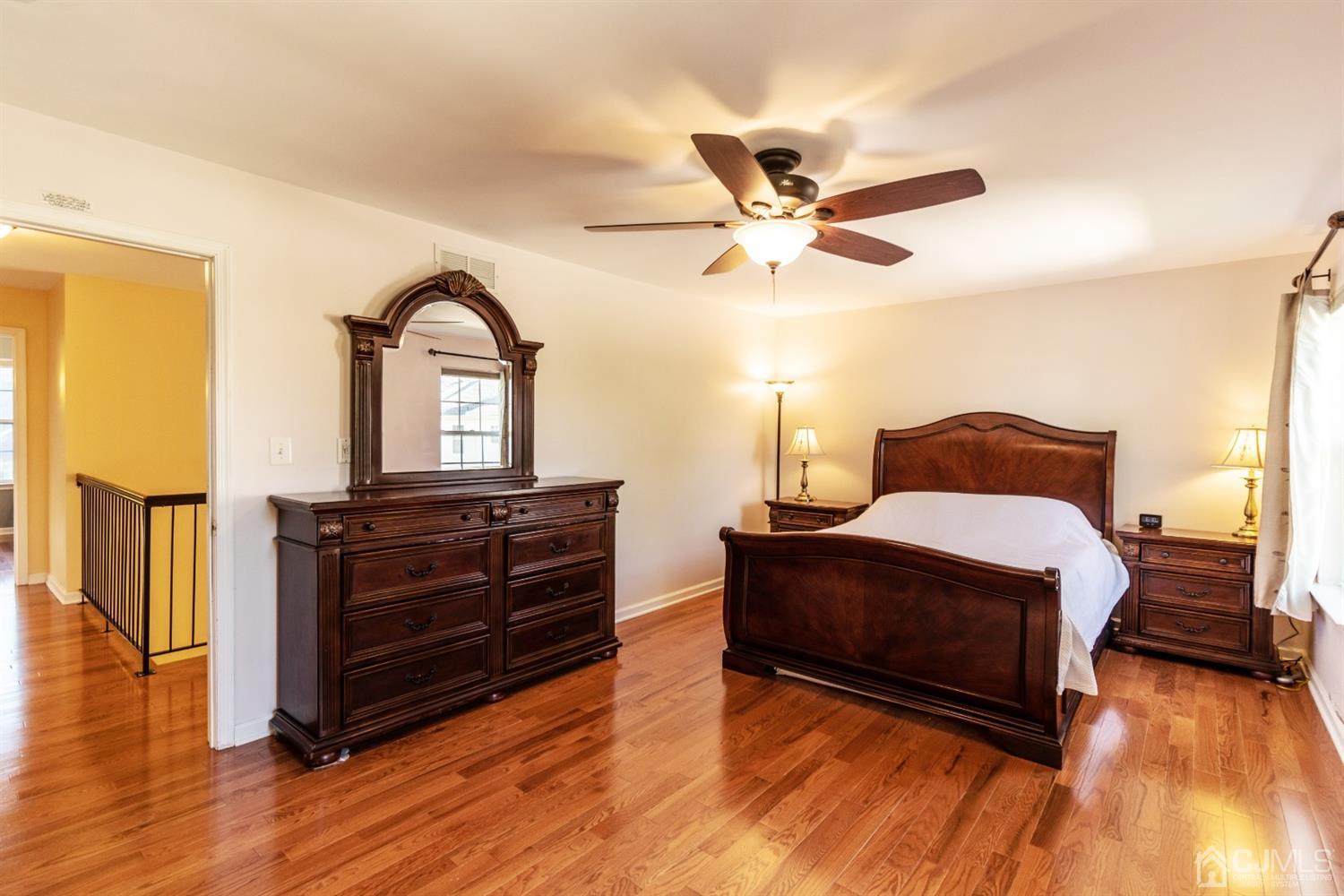 14 Pointer Place Kendall Park, NJ 08824 - Photo 20 of 34 a bedroom with a bed and wooden floor
