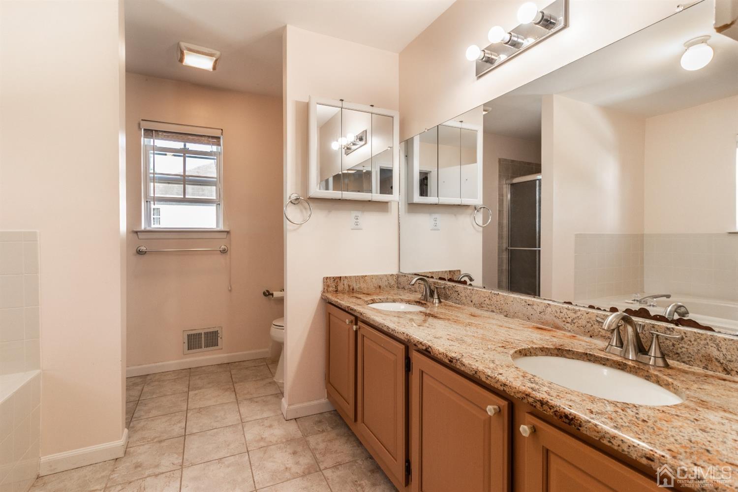 14 Pointer Place Kendall Park, NJ 08824 - Photo 25 of 34 a bathroom with a granite countertop sink and a mirror