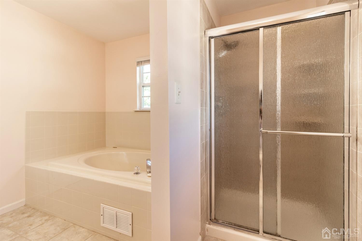 14 Pointer Place Kendall Park, NJ 08824 - Photo 27 of 34 a bathroom with a bathtub and shower