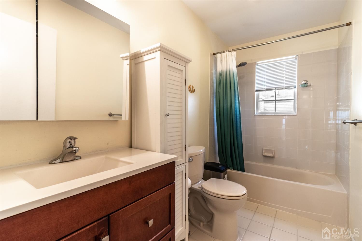 14 Pointer Place Kendall Park, NJ 08824 - Photo 28 of 34 a bathroom with a sink a toilet and shower