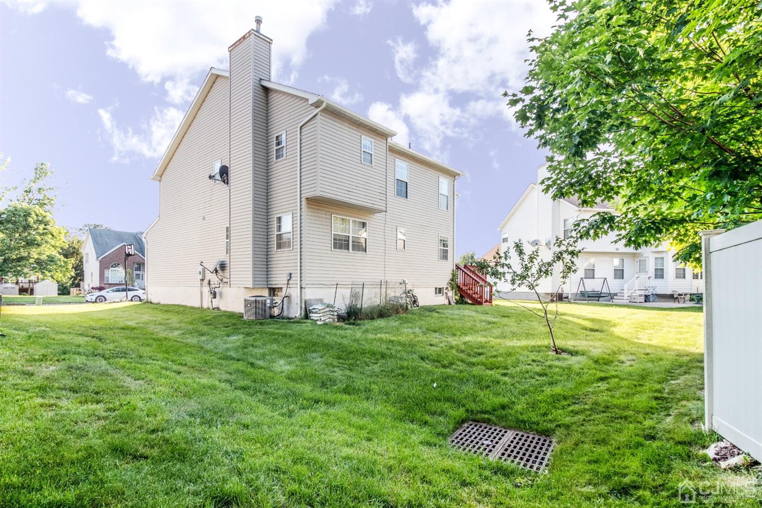 14 Pointer Place Kendall Park, NJ 08824 - Photo 32 of 34 a backyard of a house with table and chairs