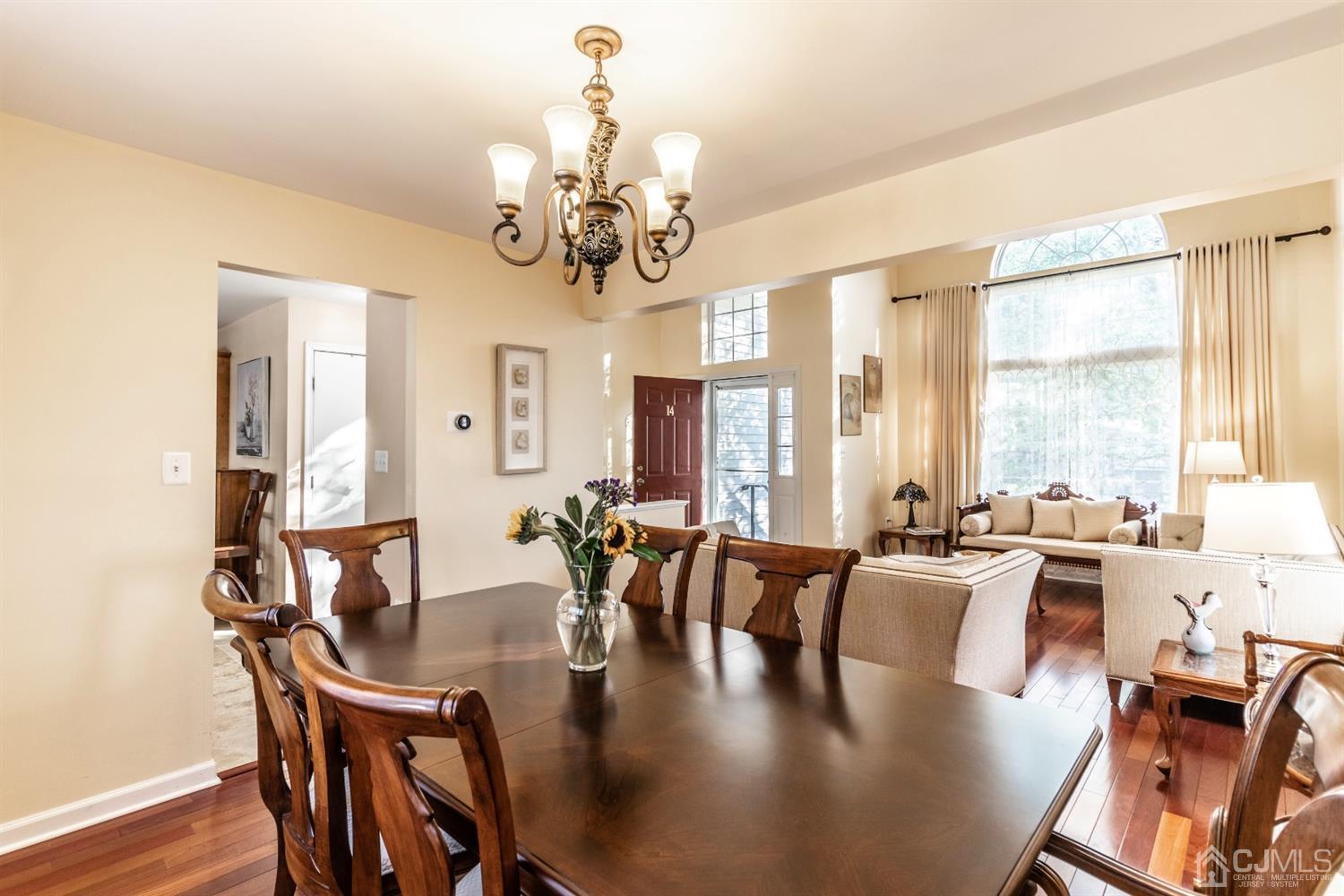 14 Pointer Place Kendall Park, NJ 08824 - Photo 9 of 34 a view of a dining room with furniture a chandelier and wooden floor