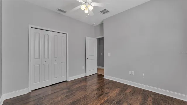 a view of an empty room with wooden floor