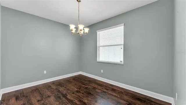 a view of wooden floor and windows in a room