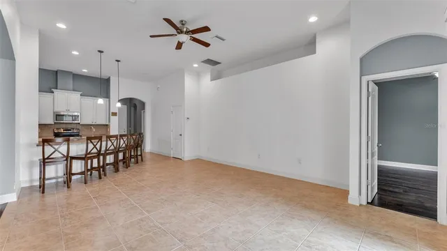 a kitchen with stainless steel appliances kitchen island granite countertop a refrigerator and a stove top oven