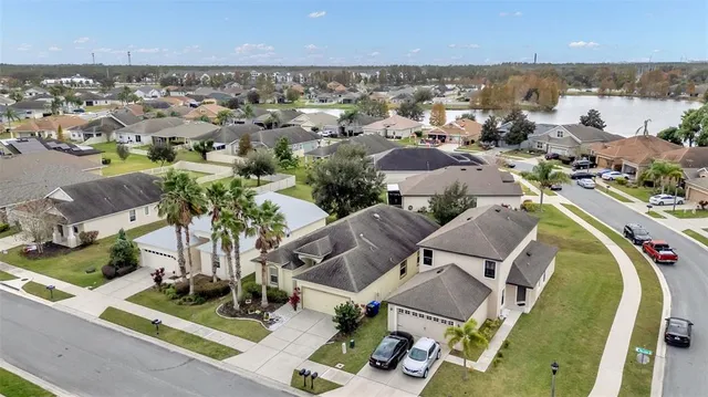 an aerial view of a house with outdoor space and lake view