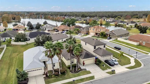 an aerial view of a house with yard swimming pool and outdoor seating