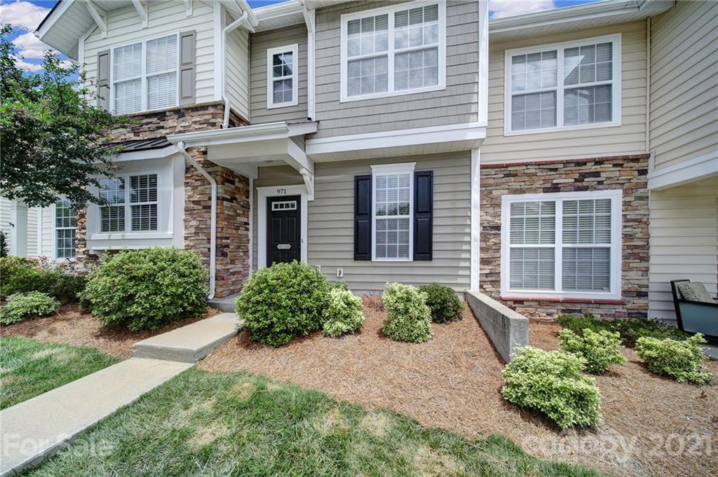 971 Copperstone Lane Fort Mill, SC 29708 - Photo 2 of 26 a front view of a brick house with a yard and potted plants