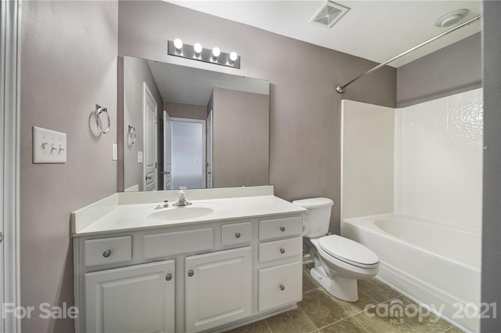 971 Copperstone Lane Fort Mill, SC 29708 - Photo 14 of 26 a bathroom with a toilet a sink a tub and mirror