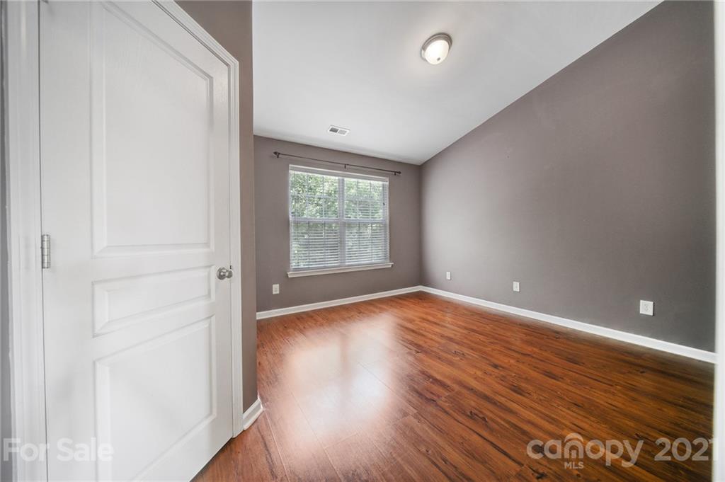 971 Copperstone Lane Fort Mill, SC 29708 - Photo 17 of 26 a view of an empty room with wooden floor and a window