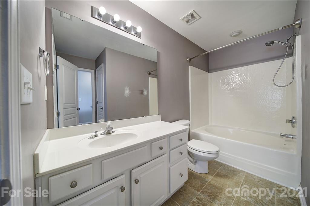 971 Copperstone Lane Fort Mill, SC 29708 - Photo 19 of 26 a bathroom with a double vanity sink toilet mirror and bathtub