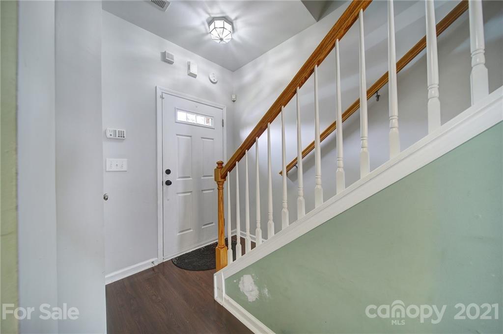 971 Copperstone Lane Fort Mill, SC 29708 - Photo 4 of 26 a view of staircase with lots of frames on wall and a chandelier