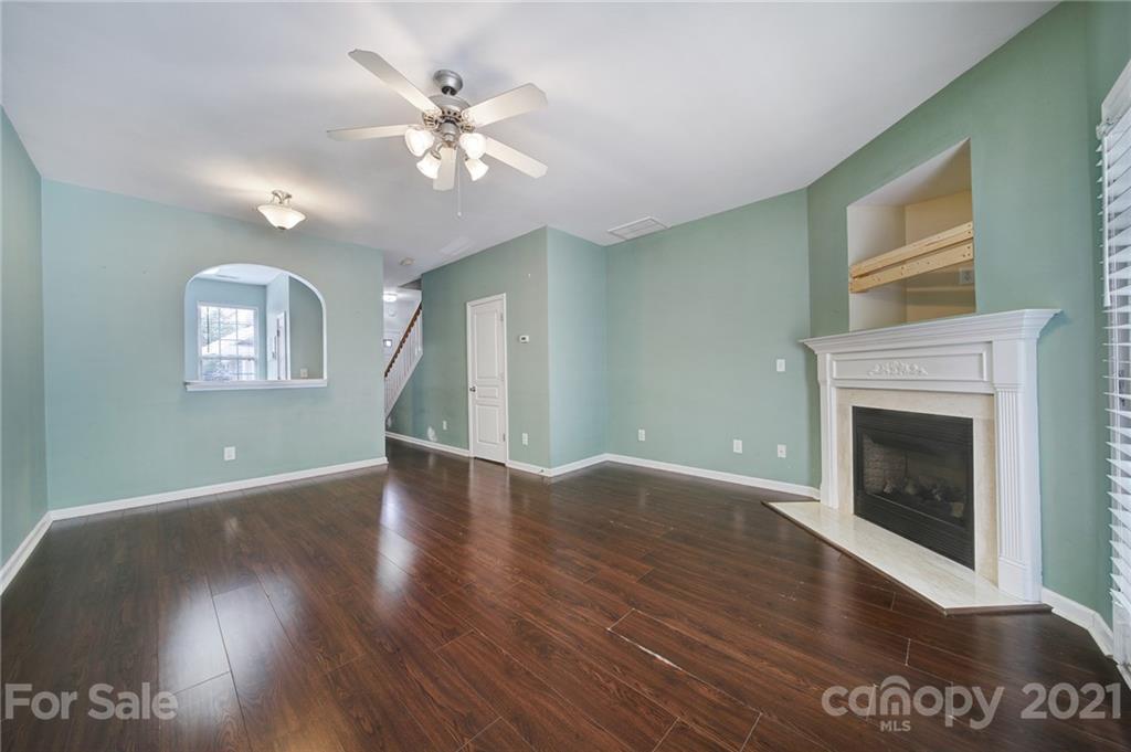 971 Copperstone Lane Fort Mill, SC 29708 - Photo 5 of 26 a view of an empty room with wooden floor and a fireplace