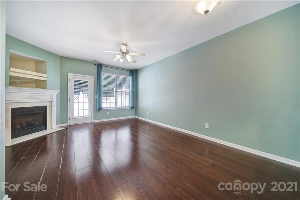 971 Copperstone Lane Fort Mill, SC 29708 - Photo 6 of 26 a view of an empty room with wooden floor fireplace and a window