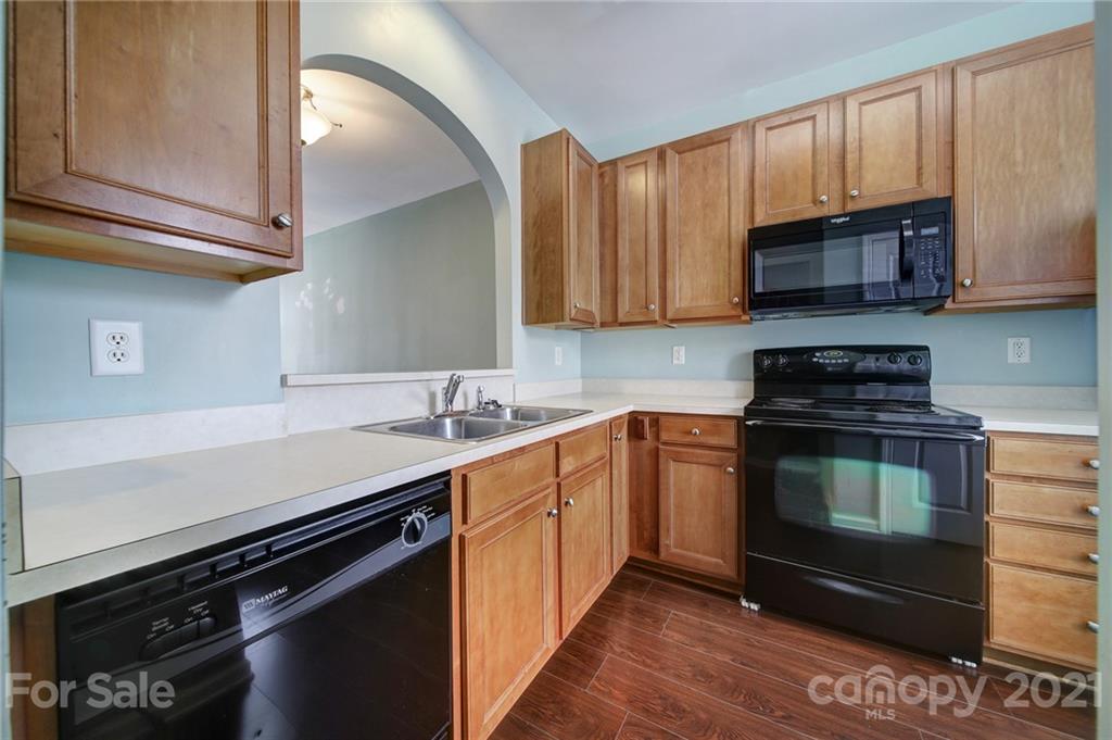 971 Copperstone Lane Fort Mill, SC 29708 - Photo 9 of 26 a kitchen with stainless steel appliances a stove a sink and a microwave